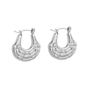 Detailed macro view of silver U-shaped hoop earrings with textured 3D grid pattern surfaces