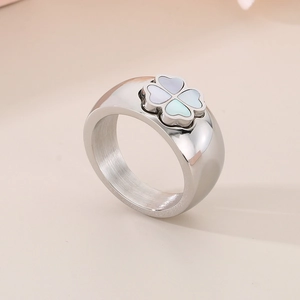 Detail showing wide silver titanium ring with clover shell inlay and polished finish