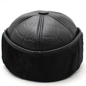 Close-up of black leather winter hat featuring lychee texture and thick warm faux fur trim