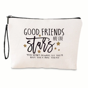 Detail of canvas makeup bag with quote and gold star print showing black zipper