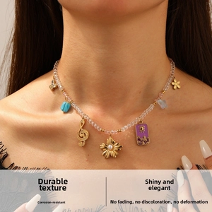 Detailed shot of bohemian beaded necklace featuring gold pendants and colorful charms