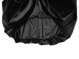 Close-up of black velvet fabric texture and elastic hem with soft lining detail