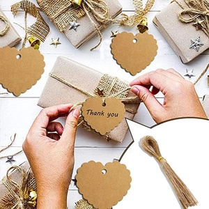 Brown heart-shaped kraft paper Thank You tags with jute twine for gift packaging