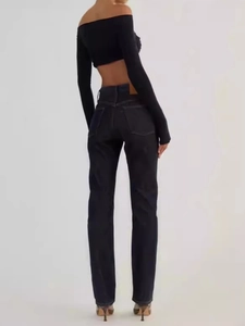 Women's black off-shoulder long sleeve crop top paired with dark straight-leg denim jeans
