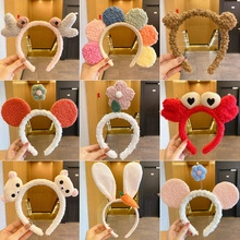 Collection of plush animal headbands in various colors including bunny and bear shapes