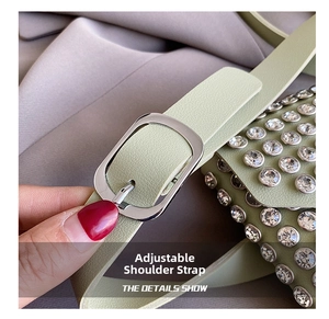 Detail view of light green rhinestone chest bag with silver adjustable strap buckle