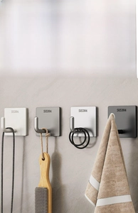 Detailed macro view of SUS304 stainless steel wall hooks in four metallic finishes
