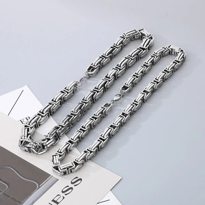 Detailed macro view of 15mm stainless steel Byzantine chain links and lobster clasp