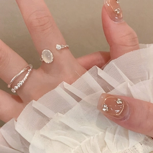 Detailed view of silver open ring featuring an oval resin stone and sparkling accents