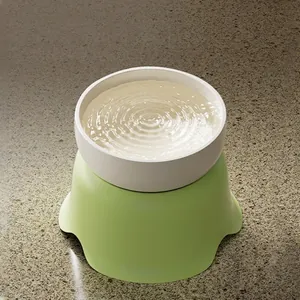 Elevated ceramic pet bowl with light green wavy base for cat neck protection