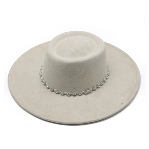 Detail of the rhinestone-studded band on an oatmeal suede boater style hat
