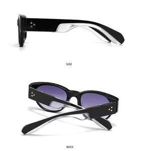 Detail view of black round sunglasses with purple gradient lenses and star rivets