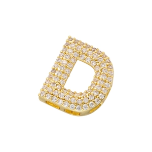 Macro detail of gold-tone letter D pendant featuring densely set shimmering cubic zirconia