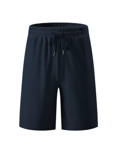 Detailed view of dark blue corduroy shorts featuring vertical ribbing and drawstring waist