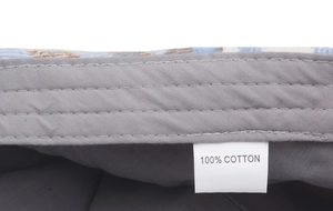 Detail of multi-thread stitching and 100% cotton label on plaid newsboy cap