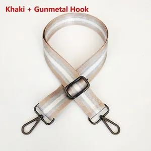 Detail of adjustable khaki nylon bag strap with grey stripes and gunmetal metal hooks