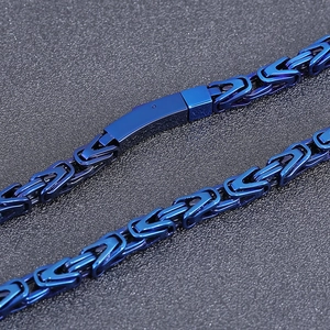 Macro shot of 6mm deep blue Byzantine weave stainless steel necklace chain detail