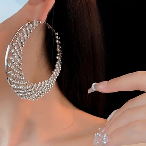 Exaggerated silver circle hoop earrings with sparkling pavé crystals for luxury party wear
