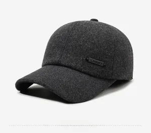 Detail of dark grey wool blend baseball cap showing SPORT badge and warm fabric texture