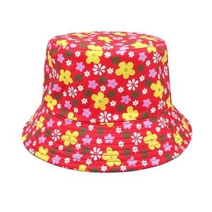 Detailed macro view of the floral bucket hat featuring colorful patterns on red canvas fabric