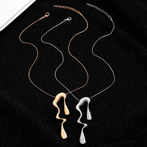 Detail of silver and gold lava-inspired irregular fluid pendants on sleek snake chains