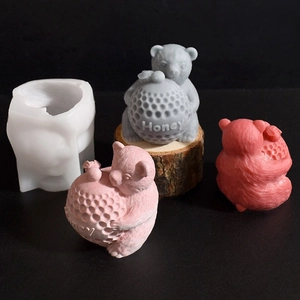 Detail of honey bear silicone mold with finished candles showing embossed Honey text
