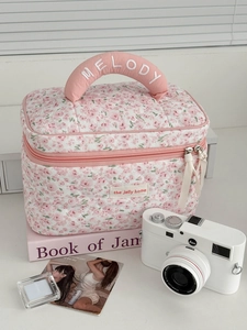 Detail of pink floral corduroy toiletry bag with Melody embroidery and double zippers