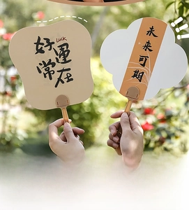 Detail of Chinese calligraphy hand fans with Luck and Future inscriptions in a garden