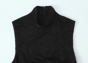 Close-up of black floral lace fabric with high neck design and hidden back zipper