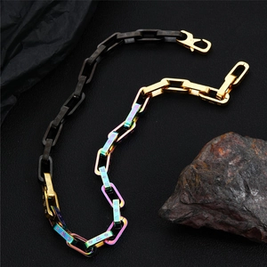 Macro detail of multicolored titanium steel chain bracelet with AW star engraving