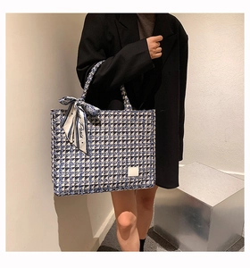 Detailed view of checkered tote bag with woven tweed texture and Paris silk scarf