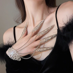 Detailed close-up of exotic silver-plated hollow flower finger armor set with chain