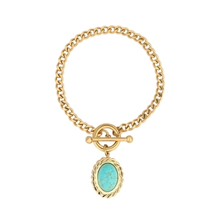 Detail of gold Cuban chain necklace with turquoise pendant and decorative toggle clasp