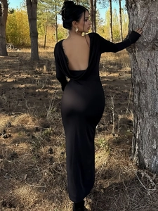 Close-up of elegant deep V backless detail on a black long sleeve bodycon maxi dress