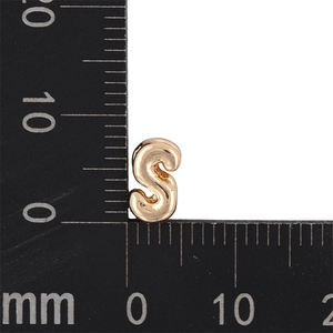 Macro scale shot of golden bubble letter S pendant showing 8mm size measurement