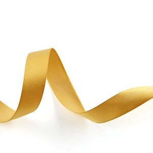 Detailed view of 1.5cm golden double-sided satin ribbon with smooth texture and elegant curves