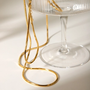 Double-layered 18K gold plated titanium steel snake chain necklace for women on glass