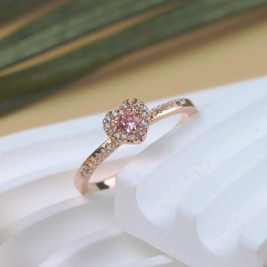 Macro view of pink heart ring in rose gold finish with micro-pave zircon detailing
