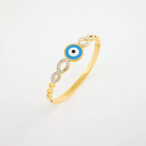 Detailed side view of gold stainless steel bangle with evil eye and infinity diamond motif