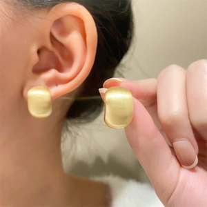 Elegant matte brushed gold bean earrings with a curved geometric design for women