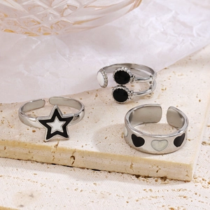 Three adjustable silver rings with black and white star and heart enamel designs
