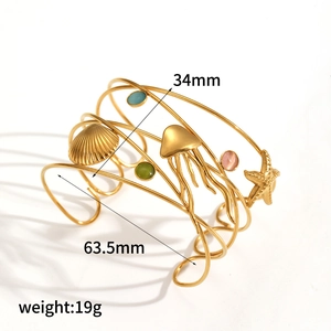 Golden ocean theme open cuff bracelet with seashell charms and colorful gemstones