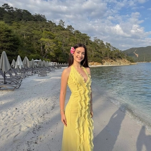 Bright yellow sleeveless ruffle maxi dress with halter neck for beach and vacation