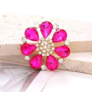 Macro shot of rose pink teardrop crystal flower accessory with gold metal base