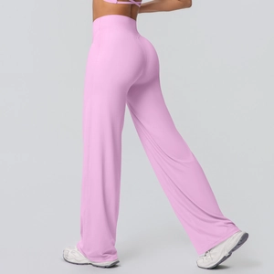 Detail view of high-waisted pink yoga flare pants showing side profile and brushed fabric
