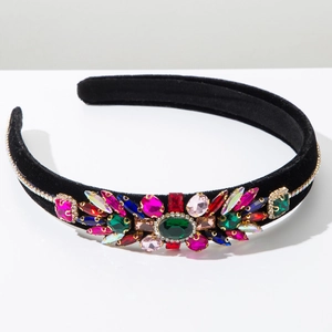 Detailed view of colorful rhinestones on a thick black velvet headband for women