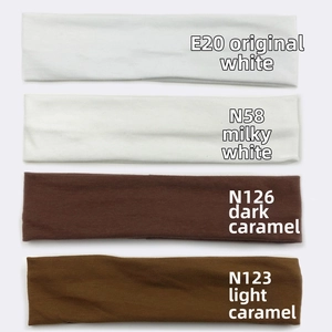Vertical stack of four knitted wide cotton headbands in white and caramel tones