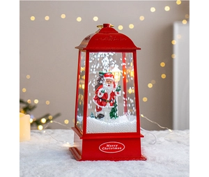 Close-up of a red Christmas snow globe lantern with Santa Claus and warm festive lights