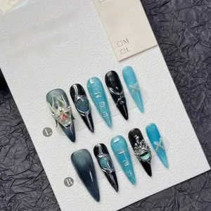 Close-up of handmade Gothic press-on nails featuring silver spider and chain details