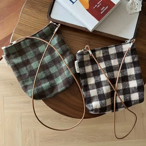 Vintage plaid woolen crossbody phone bags in green and brown patterns on wooden table